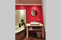 a bathroom with red walls and a sink and a mirror at COEUR de GOUDARGUES! 3 ch, 3 SDB, Extérieur, CLIM in Goudargues