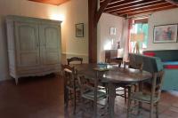 a dining room with a wooden table and chairs at Maison de charme confortable au cœur de la nature in Saint-André-de-Double