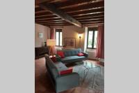 a living room with a blue couch and a table at Maison de charme confortable au cœur de la nature in Saint-André-de-Double