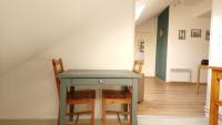 a table and chairs in a room at Studio de charme en plein centre ville in Beauvais