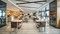 a restaurant with tables and chairs and a bar at Holiday Inn Express Shanghai Gongkang by IHG in Baoshan