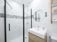 a bathroom with a shower and a sink and a mirror at T2 situé au cœur du centre historique de Dinan in Dinan