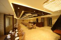 a restaurant with tables and chairs and a dining room at Hotel DVIJ INN in Jaipur