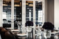 a dining room with a table with wine bottles at Sandhamn Seglarhotell in Sandhamn