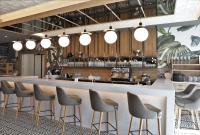 a bar with a row of stools in a restaurant at Limak Skopje Luxury Hotel in Skopje
