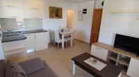 a small living room with a kitchen and a table at Apartment in Malinska&#47;Insel Krk 13118 in Sveti Vid-Miholjice