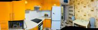 a small kitchen with yellow cabinets and a refrigerator at PortCity in Lutsk