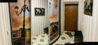 a hallway with a door and paintings on the walls at PortCity in Lutsk