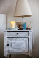 a white dresser with a lamp on top of it at La Kaz in Courseulles-sur-Mer