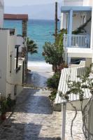 a walkway to the beach with a bench at Theofanis Studios in Agia Anna Naxos