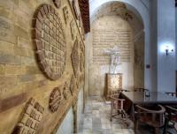 a chapel with a cross on the wall at Hotel Tugasa Convento San Francisco in Vejer de la Frontera