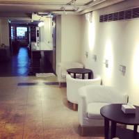 a room with white chairs and tables and a counter at Single inn- KAOHSIUNG LINSEN in Kaohsiung