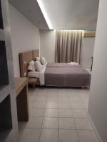 A bed or beds in a room at Jannos Beach hotel