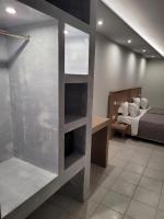 A bed or beds in a room at Jannos Beach hotel