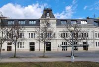 a large white building with a tower on top of it at EFI SPA Hotel Superior &amp; Pivovar in Brno