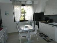 a kitchen with a table and chairs and a window at BEL APPARTEMENT TYPE F3 in Amélie-les-Bains-Palalda