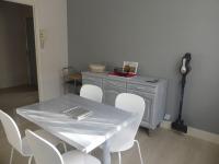 a table and chairs with a white table and a table and a table and chairs at BEL APPARTEMENT TYPE F3 in Amélie-les-Bains-Palalda