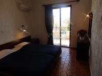 Postel nebo postele na pokoji v ubytování Emmanuel Apartments