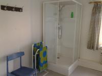 a bathroom with a shower and a blue chair at Chambres d&#39;hôtes de la Quairelle in Gerpinnes