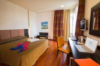 A bed or beds in a room at Victoria Terme Hotel