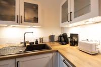 a kitchen counter with a sink and a microwave at Le LOUIS XV halte romantique à Metz centre in Metz