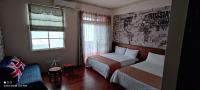 a small room with two beds and a window at HL Sea Homestay in Hualien City