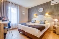 a bedroom with a large bed and a window at Hôtel Saint Albert in Sarlat-la-Canéda