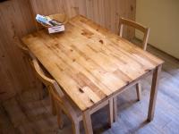 a wooden table with two chairs and a box on it at Sleeping Boot Hostel in Hualien City