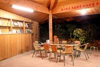 a patio with a table and chairs in a building at Alishan Fenqihu Green Land Homestay in Guanghua