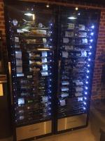 a wine rack filled with lots of wine bottles at Ferme Delgueule in Tournai