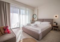 A bed or beds in a room at Aelia Seaside Luxury Suites