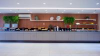 a lobby with a counter with food on it at Villa Park Hotel in Natal