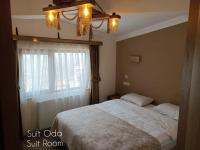 A bed or beds in a room at Mersu A'la Konak Otel