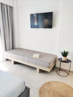 A television and/or entertainment centre at Aelia Seaside Luxury Suites