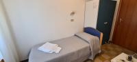 Łóżko lub łóżka w pokoju w obiekcie Hotel Astoria