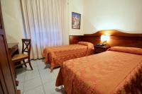 Posteľ alebo postele v izbe v ubytovaní Hotel Pavone