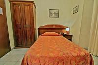 Posteľ alebo postele v izbe v ubytovaní Hotel Pavone