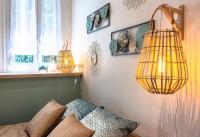a living room with two hanging lamps and a couch at Studio climatisé à 50m des plages in Nice