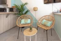 two wicker chairs and a table in a kitchen at Studio climatisé à 50m des plages in Nice