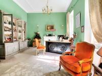 a living room with a chair and a fireplace at The Originals Boutique, Hôtel du Parc, Cavaillon (Inter-Hotel) in Cavaillon