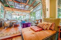 a living room with a couch and tables and windows at 花蓮 達芙妮花園民宿 in Ji&#39;an