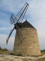 a stone windmill sitting on top of a field at Gîte du ruisseau in Nissan-lez-Enserune