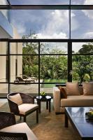 a living room filled with furniture and a large window at Capella Singapore in Singapore