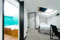a small room with two beds and a mirror at Atypik Hotel in Clichy