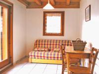 a living room with a couch and a table at A detached chalet for 6 people with views of Veysonnaz in Le Villard
