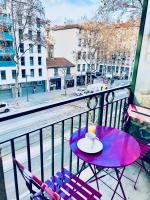 a purple table with a cup of coffee on a balcony at Chez Marie in Lyon