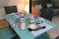 a blue table with cups and dishes on it at Appartement de charme rue du Château in Auray