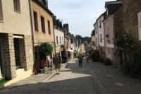 a group of people walking down a street at Appartement de charme rue du Château in Auray