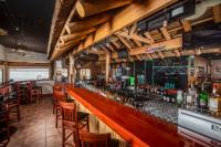 The Nautical Beachfront Resort في مدينة ليك هافاسو: بار في مطعم به جدران وكراسي خشبية