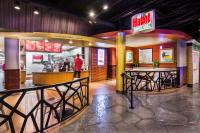 a restaurant with a man standing at a counter at Circus Circus Reno, A Caesars Destination in Reno